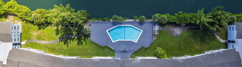 Overhead view of the lakeside pool and grounds at Lakeshore Presidential Apartments