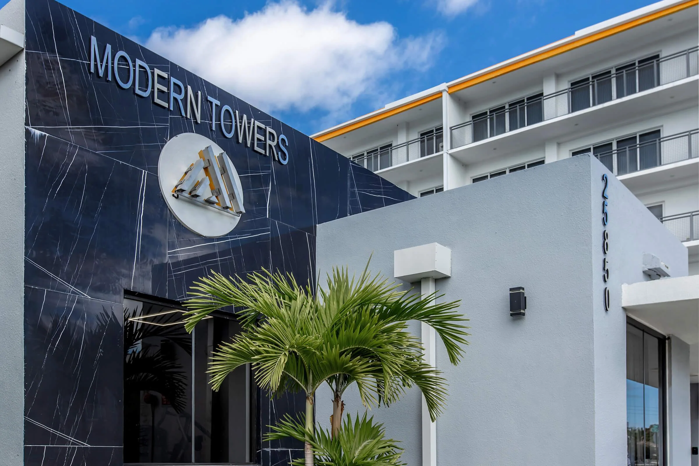 Modern Towers name and emblem above the community entrance.